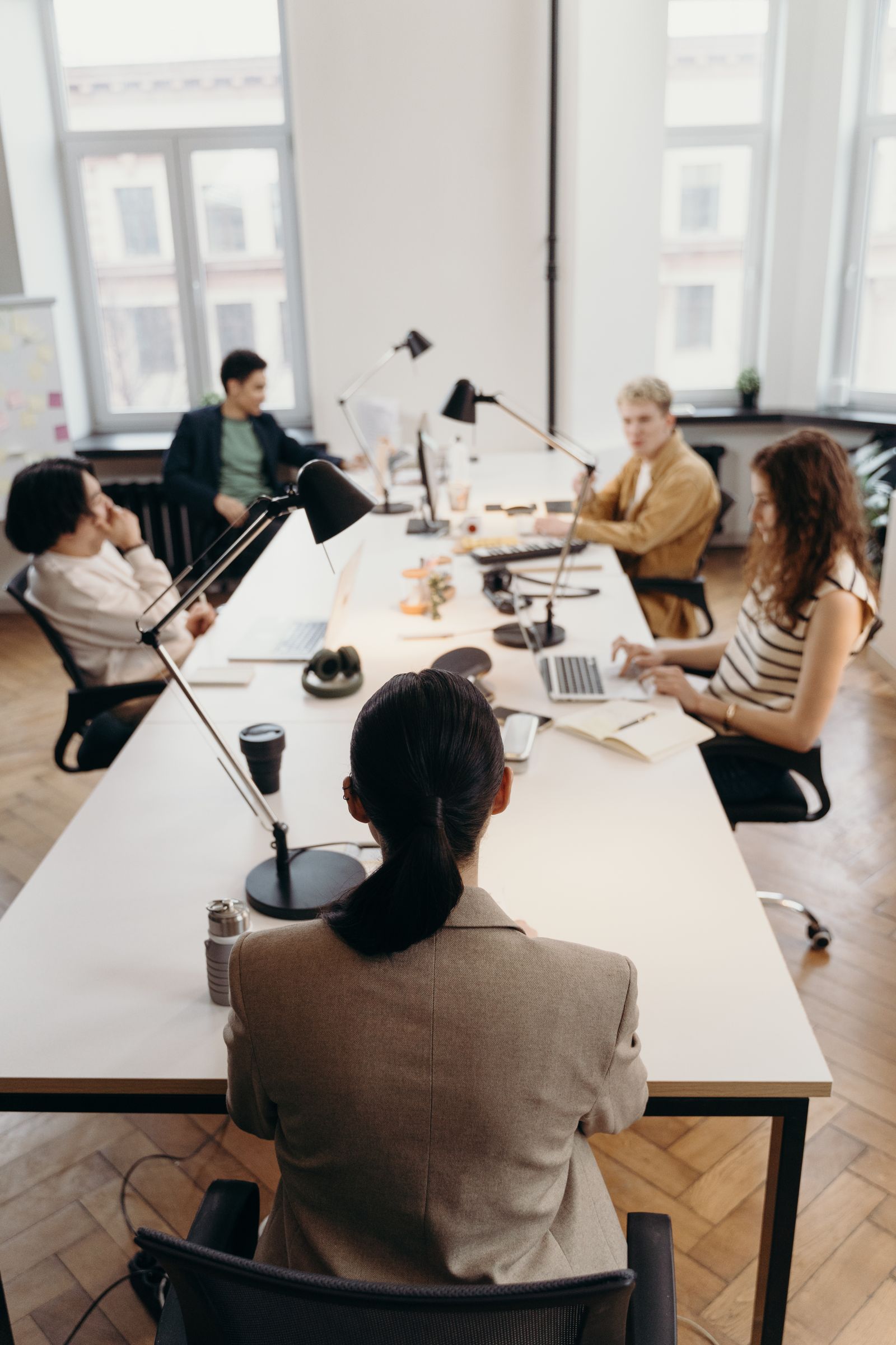 An overhead view of a diverse group of colleagues gathered around a shared table.