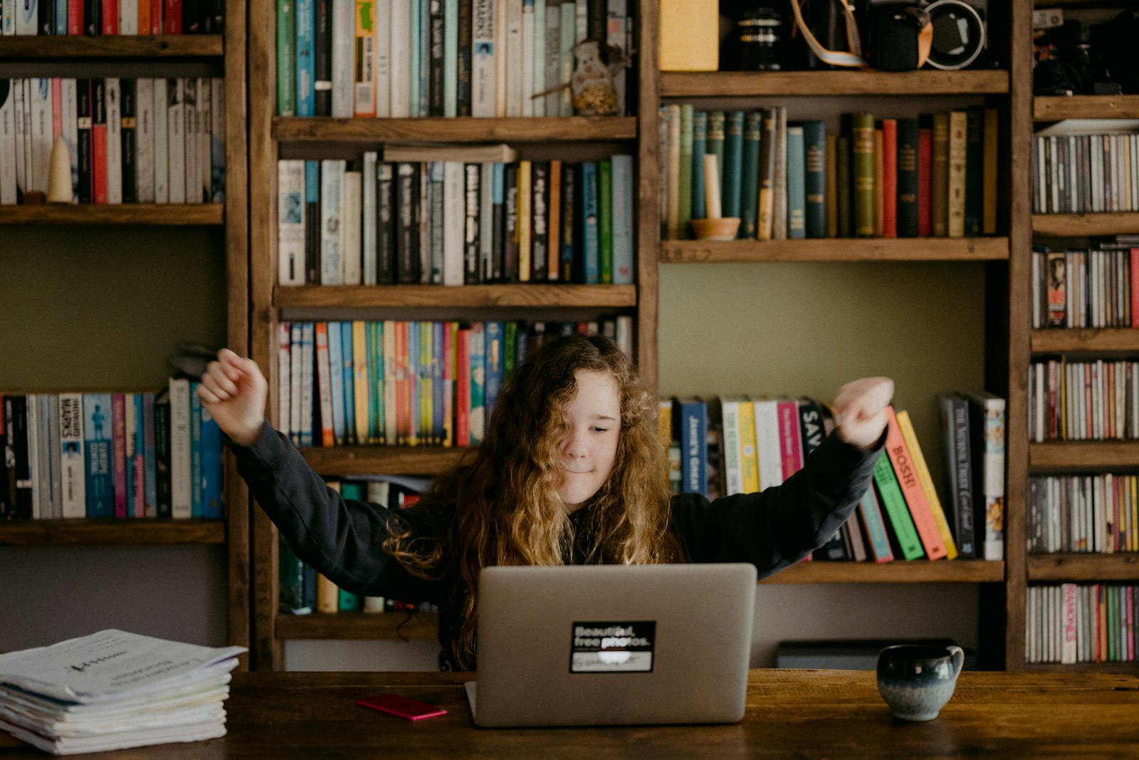 Person comfortably exploring digital resources on a laptop at home