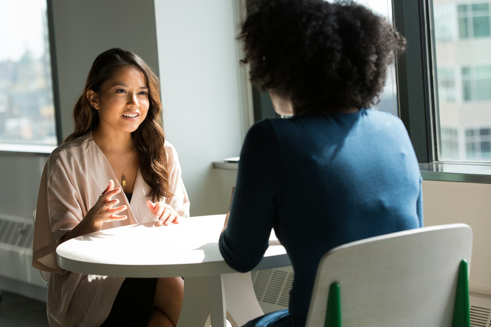 Two people having a private supportive conversation at a table