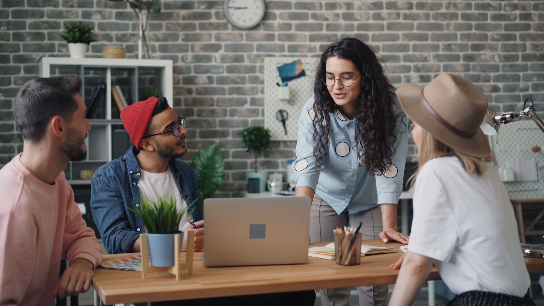 A small group of workplace professionals in a genuine, collaborative conversation.